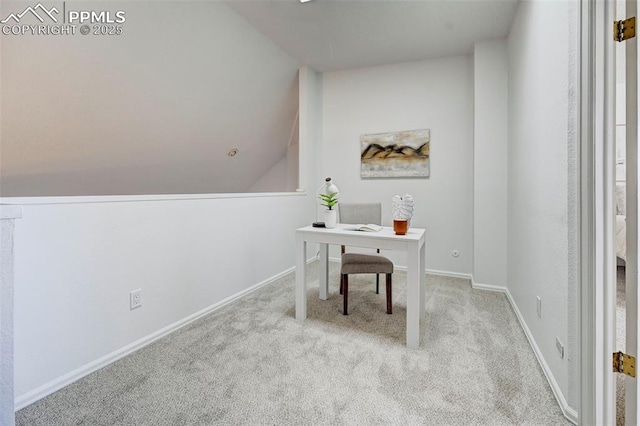 carpeted office with baseboards and lofted ceiling