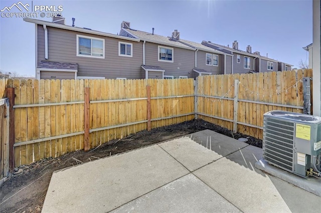 view of patio / terrace featuring fence, a residential view, and central AC