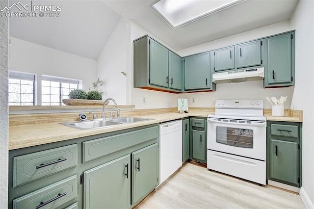 kitchen with under cabinet range hood, white appliances, green cabinetry, and a sink