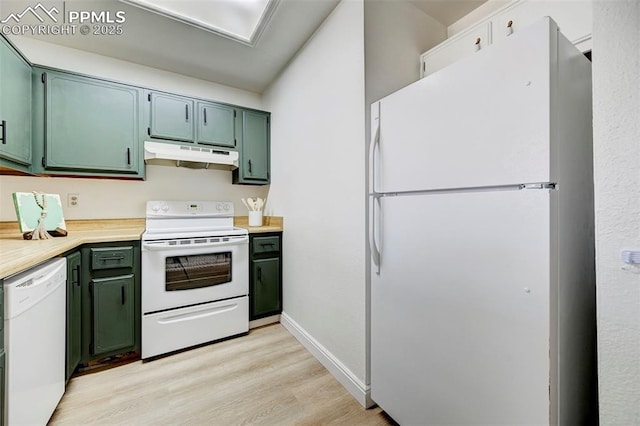 kitchen featuring under cabinet range hood, white appliances, and green cabinetry