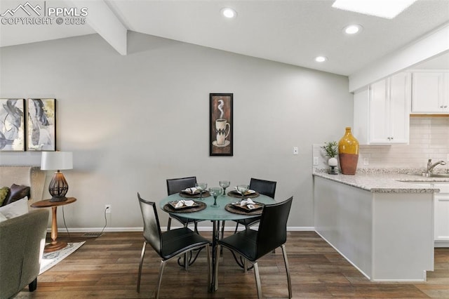 dining room featuring lofted ceiling with beams, dark wood-style flooring, recessed lighting, and baseboards