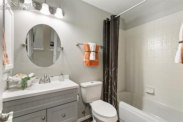 bathroom featuring shower / bath combination with curtain, a textured wall, vanity, and toilet