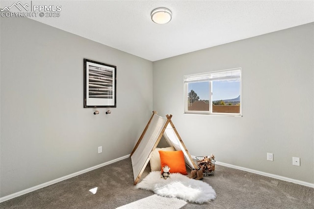 rec room featuring carpet and baseboards