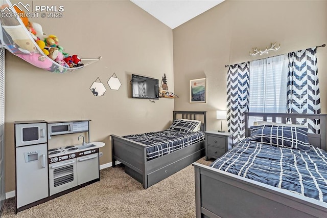 carpeted bedroom with vaulted ceiling and baseboards