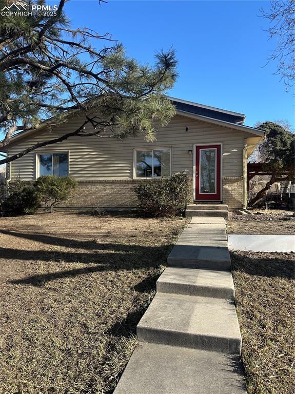 view of front of house with brick siding