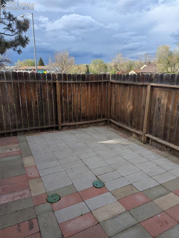 4211 Hunts Mill Ter, Colorado Springs, CO 80910 - view of patio / terrace with fence