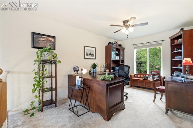 office space with light carpet and ceiling fan