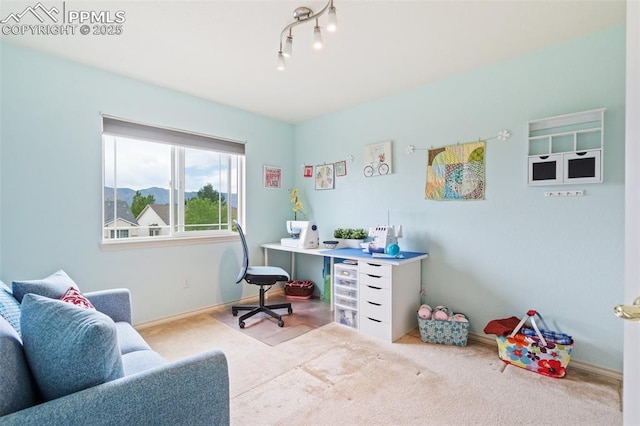 carpeted home office featuring baseboards