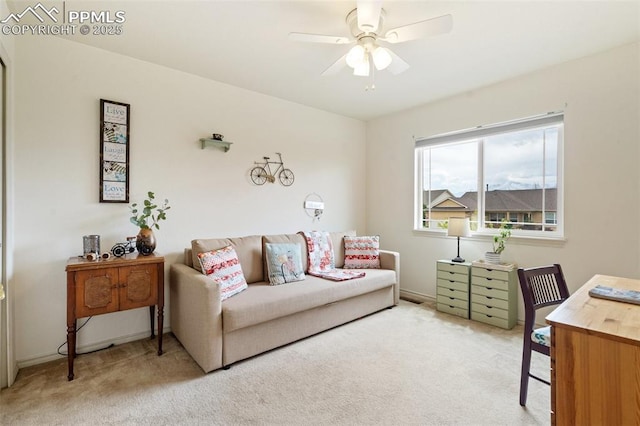 carpeted home office featuring ceiling fan