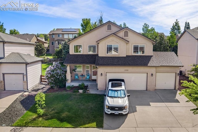 traditional-style home with covered porch, driveway, a front lawn, and stucco siding