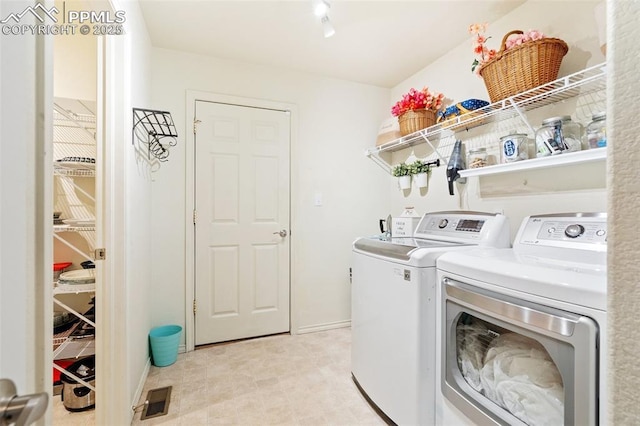 laundry area with washer and dryer, laundry area, and visible vents