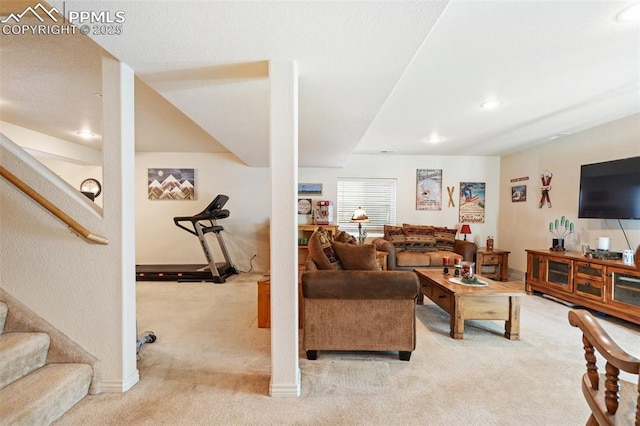 living room with recessed lighting, light colored carpet, baseboards, and stairs