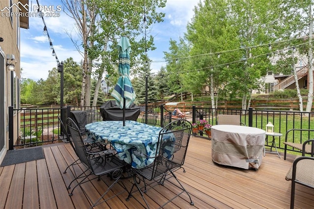 deck with outdoor dining area