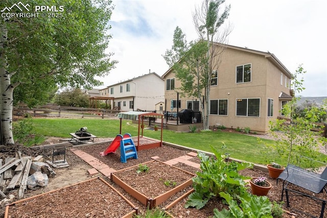 exterior space with a vegetable garden and fence