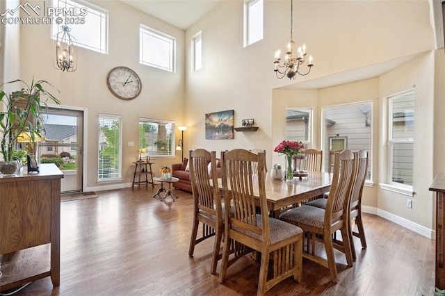 dining room featuring plenty of natural light, a notable chandelier, and wood finished floors