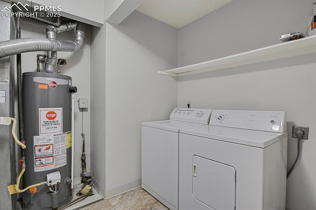 washroom with water heater, laundry area, independent washer and dryer, and baseboards