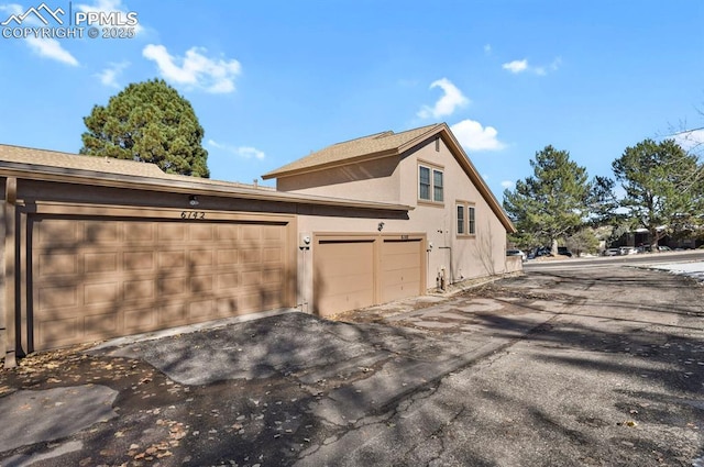 view of property exterior featuring a garage and stucco siding