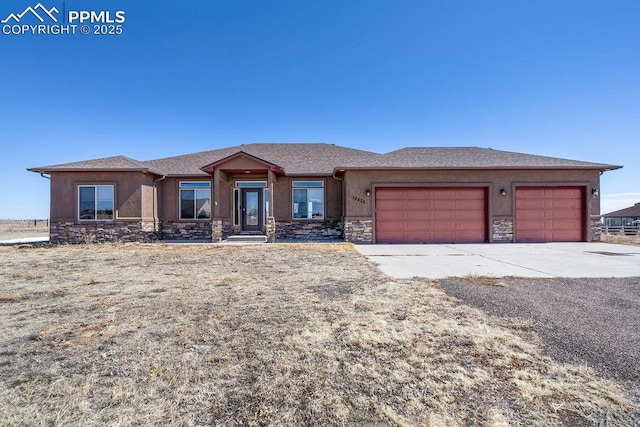 prairie-style home featuring an attached garage, stone siding, driveway, and stucco siding