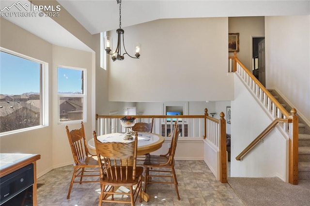 dining room featuring vaulted ceiling, stairway, a chandelier, and baseboards