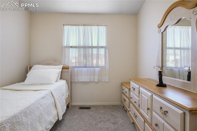 bedroom with baseboards, visible vents, and light colored carpet