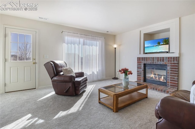 carpeted living area with a brick fireplace, visible vents, and baseboards