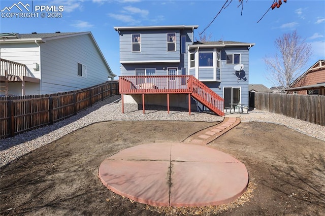 rear view of house with a patio area, a fenced backyard, stairway, and a deck