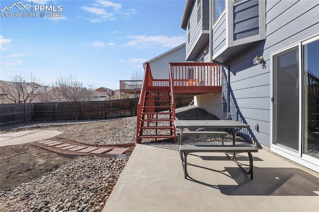 view of patio / terrace featuring a deck, stairway, and a fenced backyard