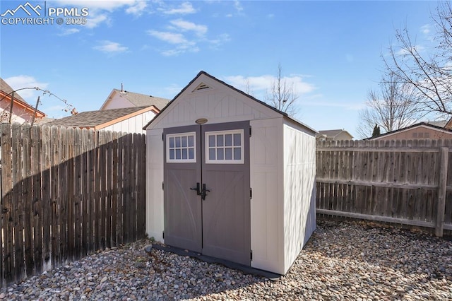 view of shed featuring a fenced backyard