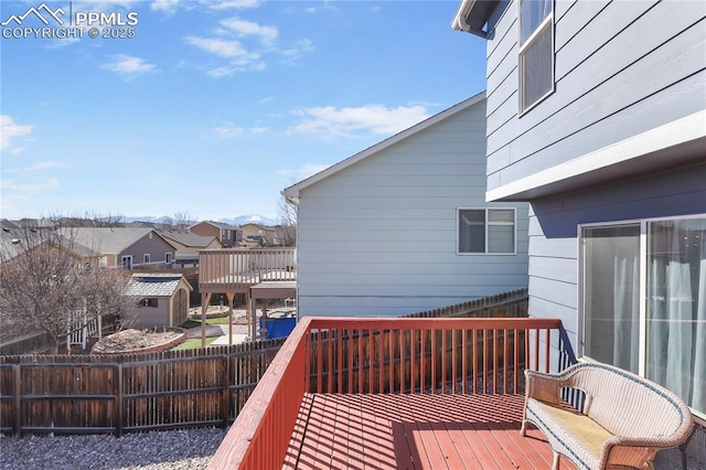 wooden terrace with a fenced backyard and a residential view