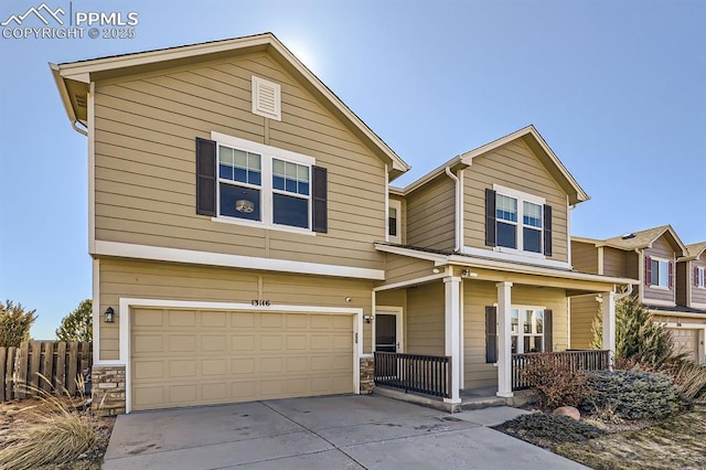 view of front facade featuring driveway, stone siding, an attached garage, fence, and a porch