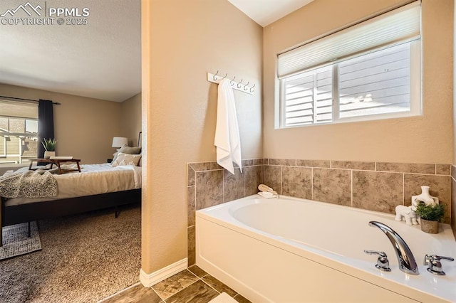 full bath with a garden tub, connected bathroom, and baseboards