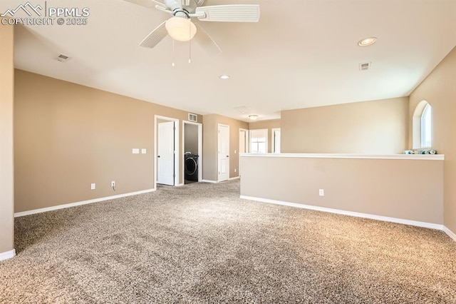 carpeted empty room featuring a wealth of natural light, visible vents, and baseboards