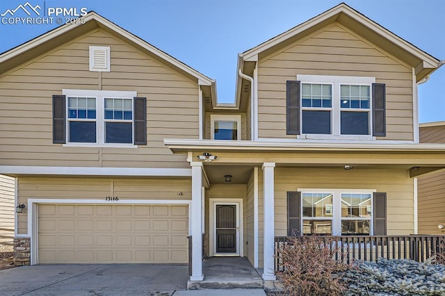 view of front of home featuring driveway, a porch, and an attached garage