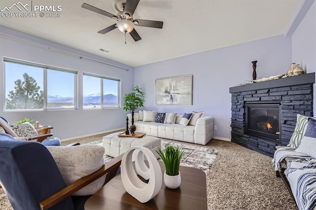 living area featuring carpet, a fireplace, visible vents, ceiling fan, and baseboards