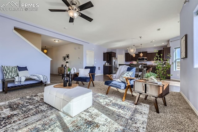 living room featuring baseboards and a ceiling fan