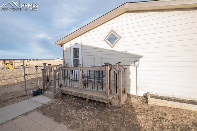 exterior space with fence and a wooden deck