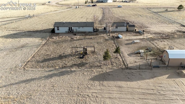 birds eye view of property with a rural view