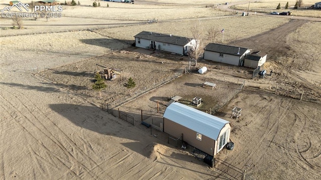 birds eye view of property with a rural view