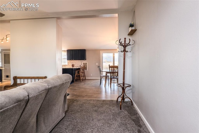 interior space featuring baseboards and dark wood-type flooring