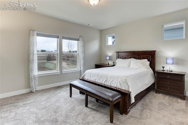 bedroom with light carpet, visible vents, and baseboards