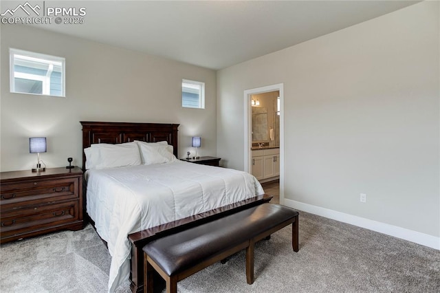 bedroom featuring ensuite bath, baseboards, and carpet flooring