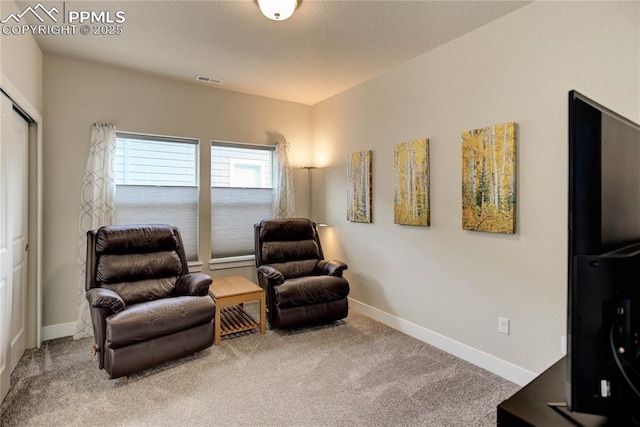 living area featuring carpet floors, visible vents, and baseboards