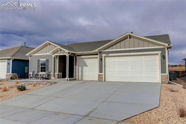 craftsman-style home with stone siding, board and batten siding, an attached garage, and driveway