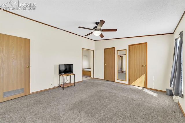 interior space with carpet, crown molding, visible vents, vaulted ceiling, and a textured ceiling