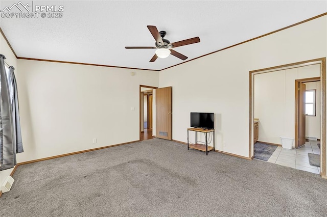 unfurnished living room featuring ornamental molding, carpet flooring, ceiling fan, and baseboards