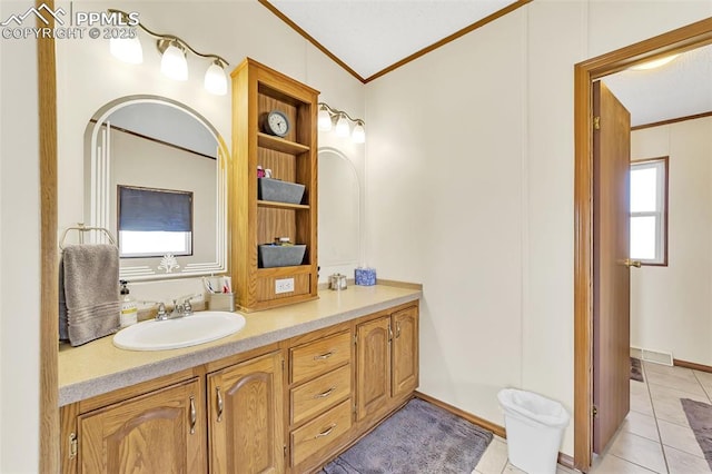 bathroom with tile patterned flooring, crown molding, and vanity