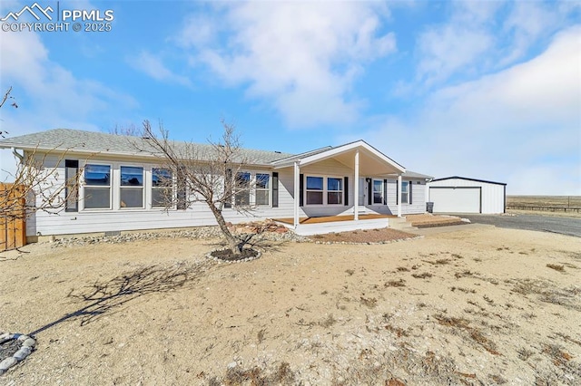 single story home with a garage and an outdoor structure