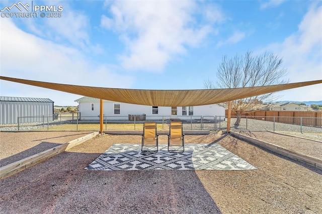 surrounding community with fence and a patio