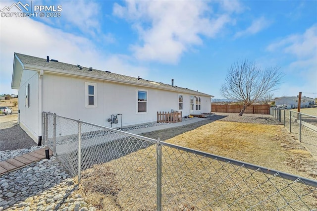 back of property featuring a fenced backyard