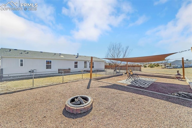 exterior space featuring fence and a fire pit